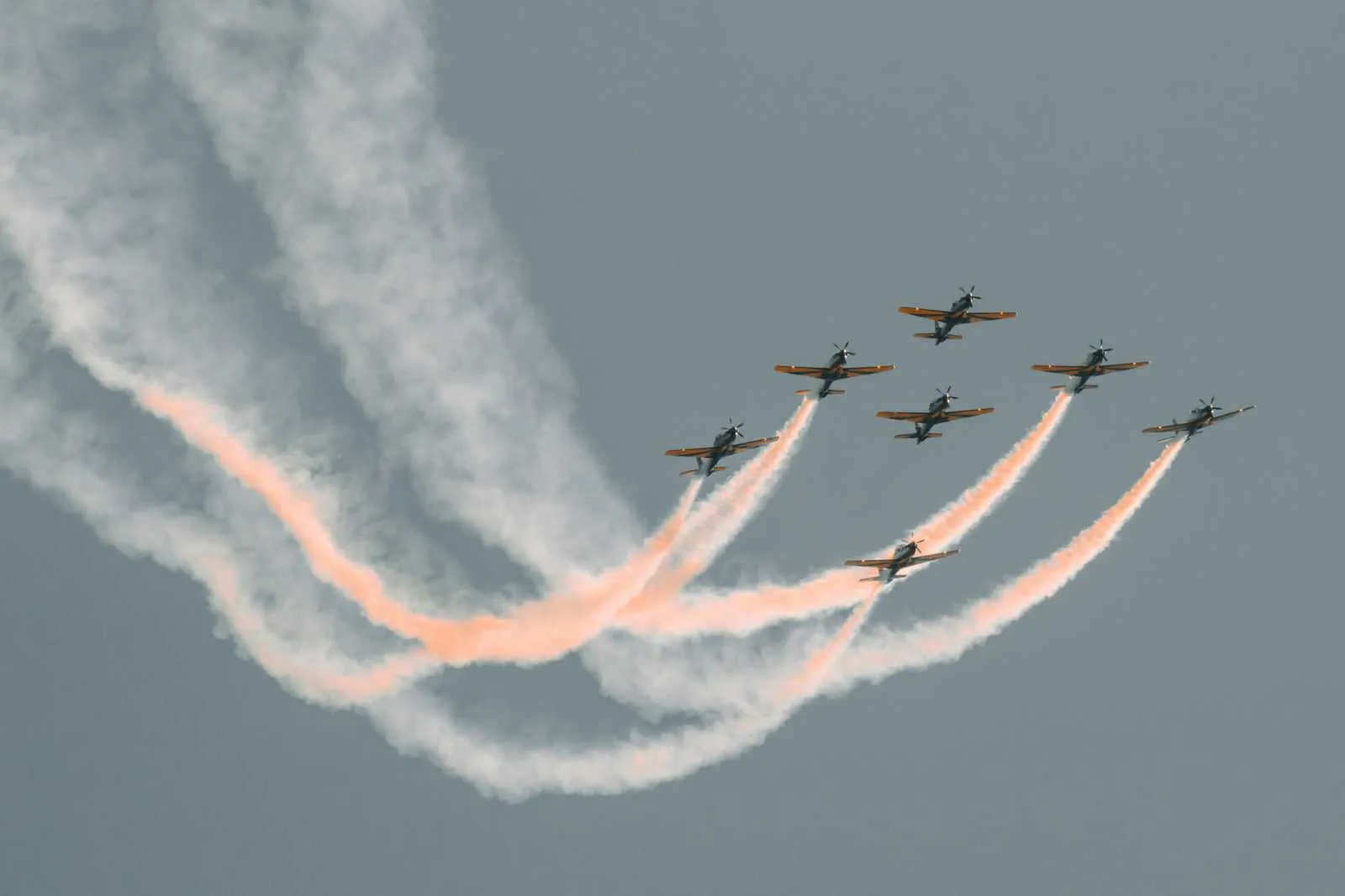 Fighter jets flying in tight formation leaving smoke trails, representing the speed of SD-WAN link bonding.