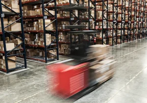 Blurred forklift moving quickly through a large distribution warehouse relying on SD-WAN for logistics.