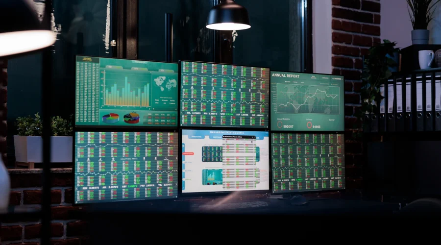 Multi-monitor display showing detailed network dashboards managed by enterprise private WAN support teams