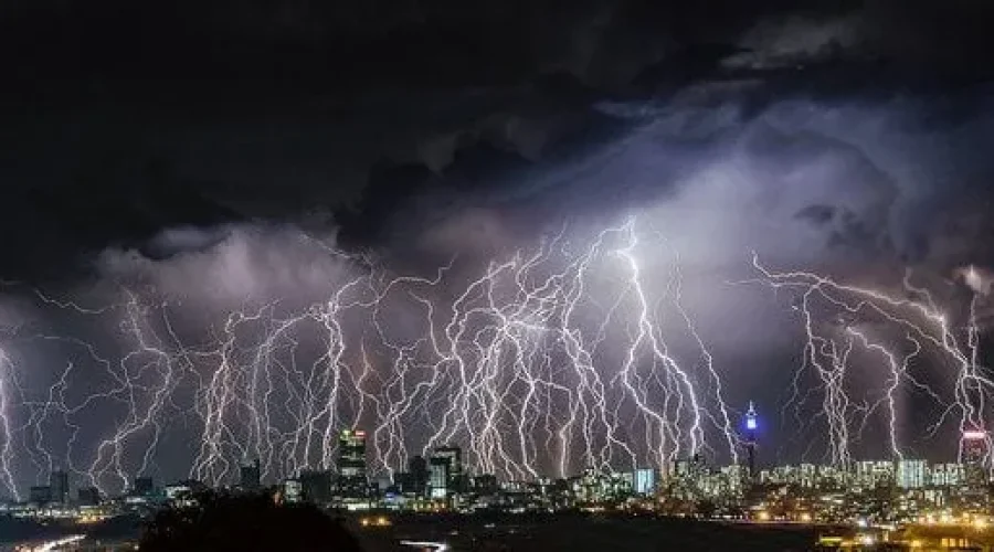  Lightning storm over a city skyline at night, illustrating a broadcast storm stopped by network switch broadcast filtering. 