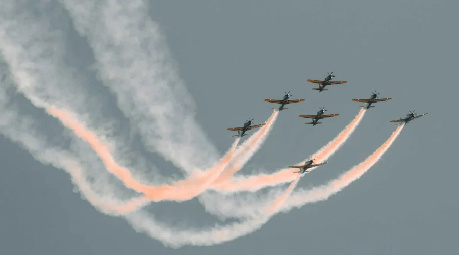Fighter jets flying in tight formation leaving smoke trails, representing the speed of SD-WAN link bonding.