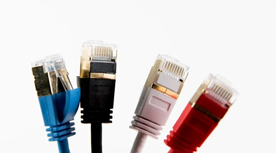 Three colorful RJ45 ethernet connectors facing forward, showcasing the ends of twisted pair LAN cables.