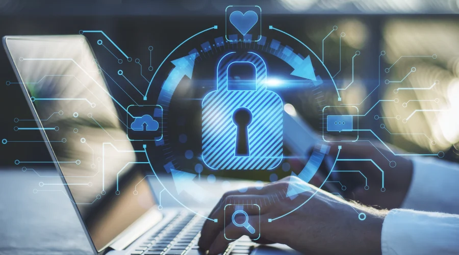 Professional typing on a laptop protected by a glowing digital padlock and vendor-agnostic cybersecurity